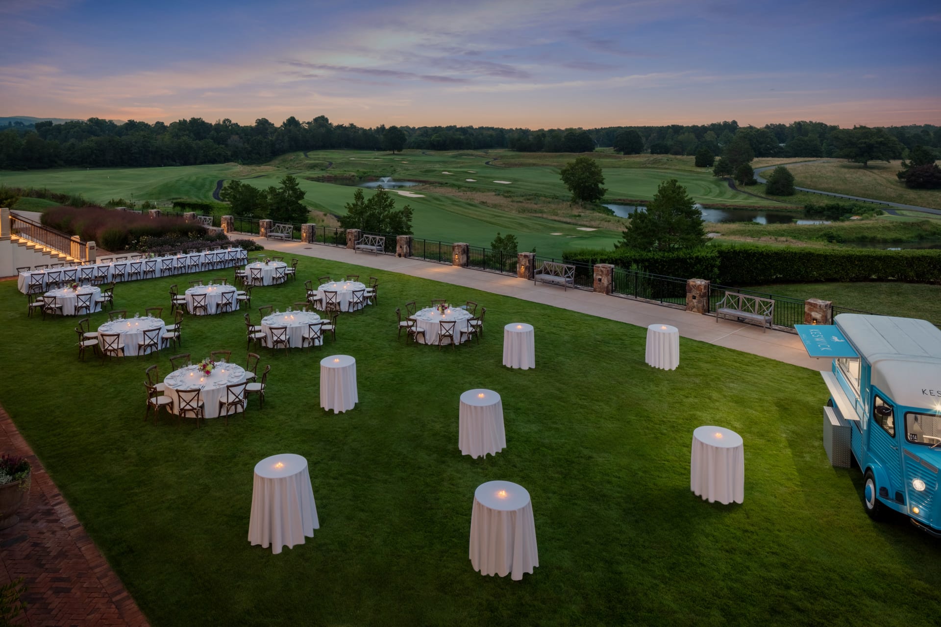 Cocktail tables set at dusk on the Patio at Keswick Hall